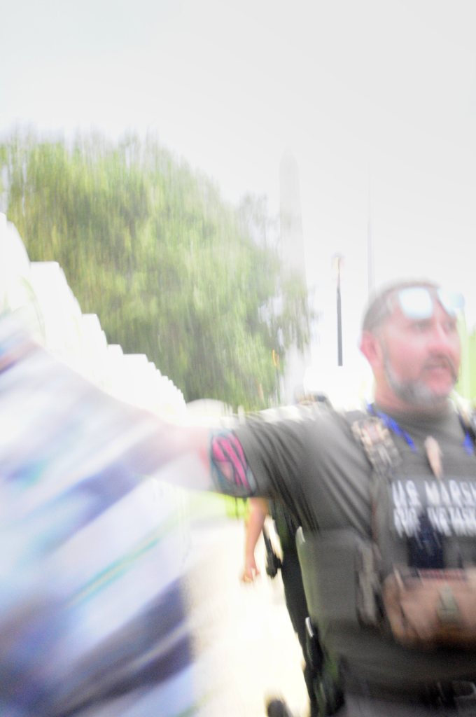 Officer in a U.S. Marshals vest directing attendees