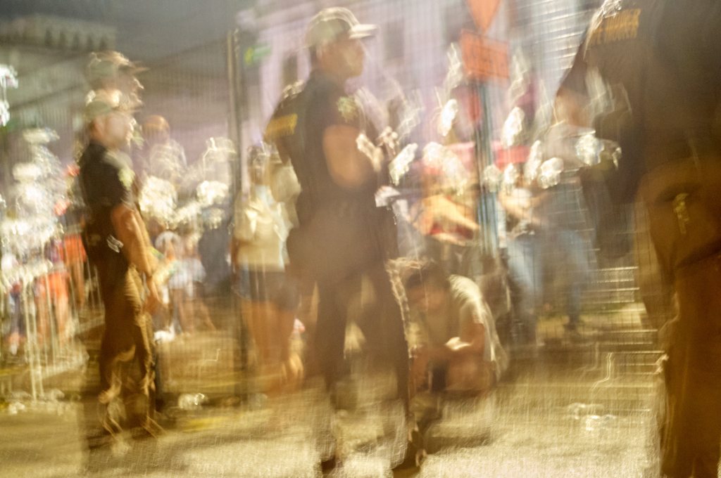 Blurred scene of officers around a man on the pavement
