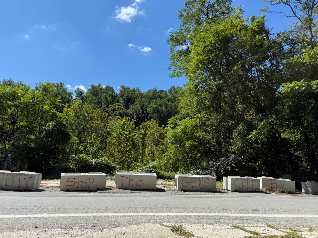 Concrete barriers along River Road with painted words
