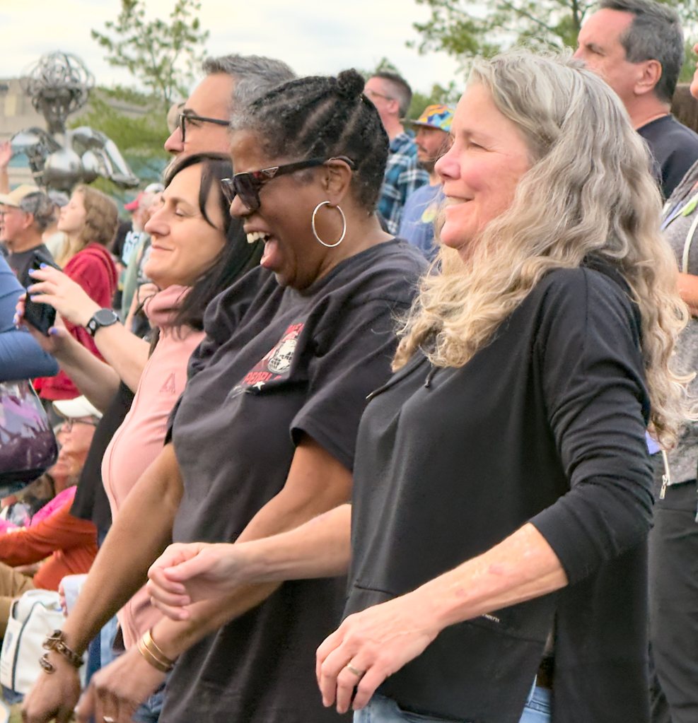 Festivalgoers laughing and singing on the lawn