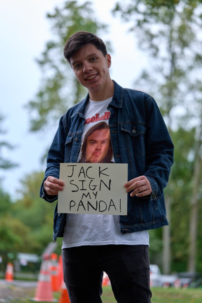 Fan holding a sign reading Jack Sign My Panda