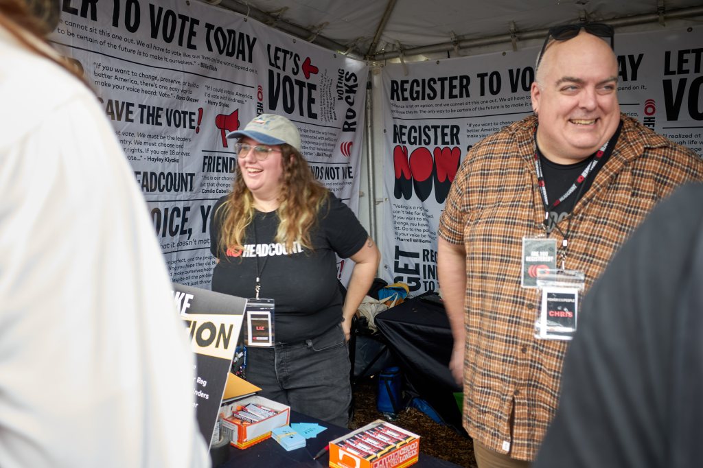 Two HeadCount workers greeting festivalgoers at a voter-registration tent